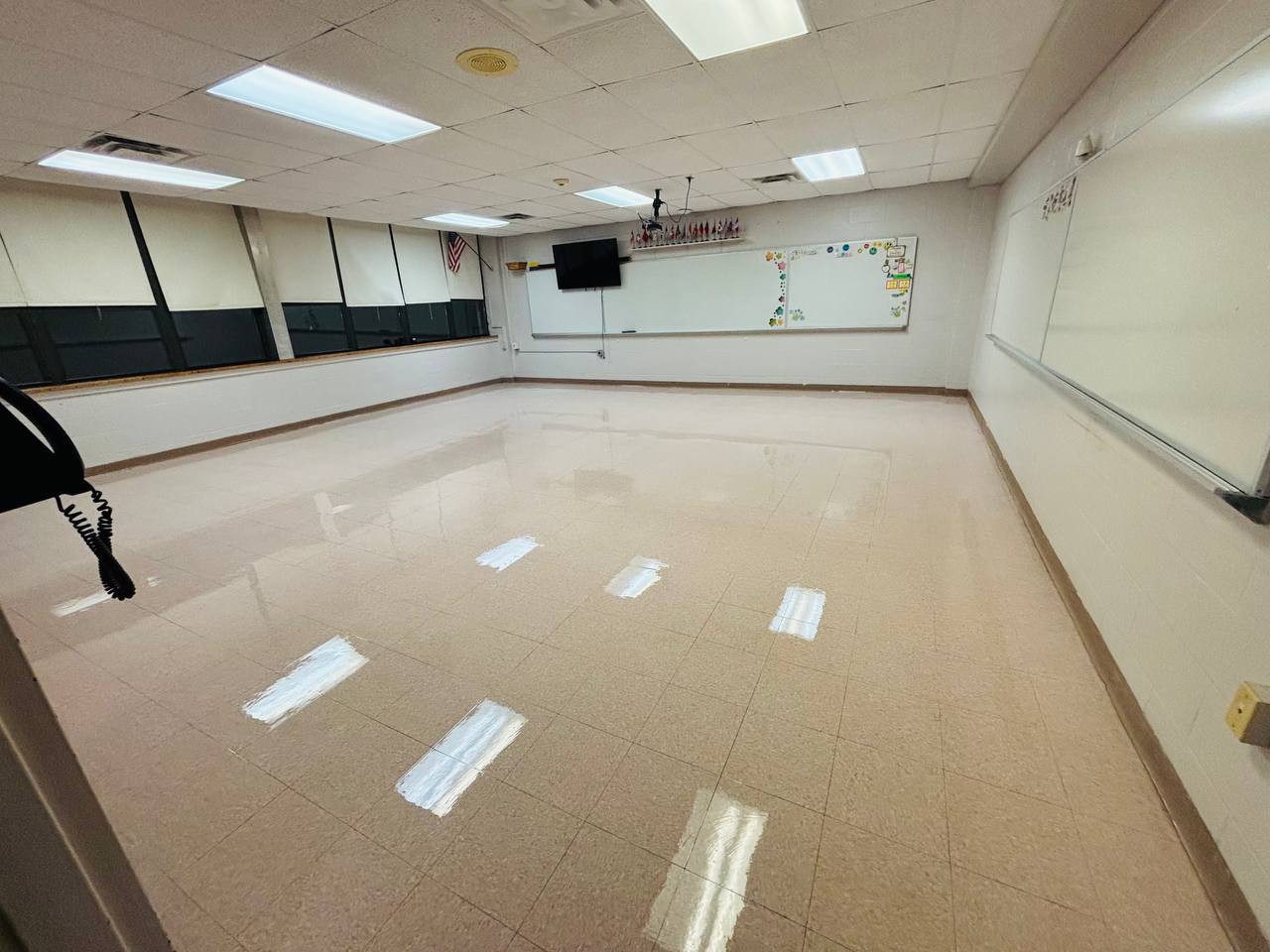 Wide view of reflective classroom flooring and whiteboards