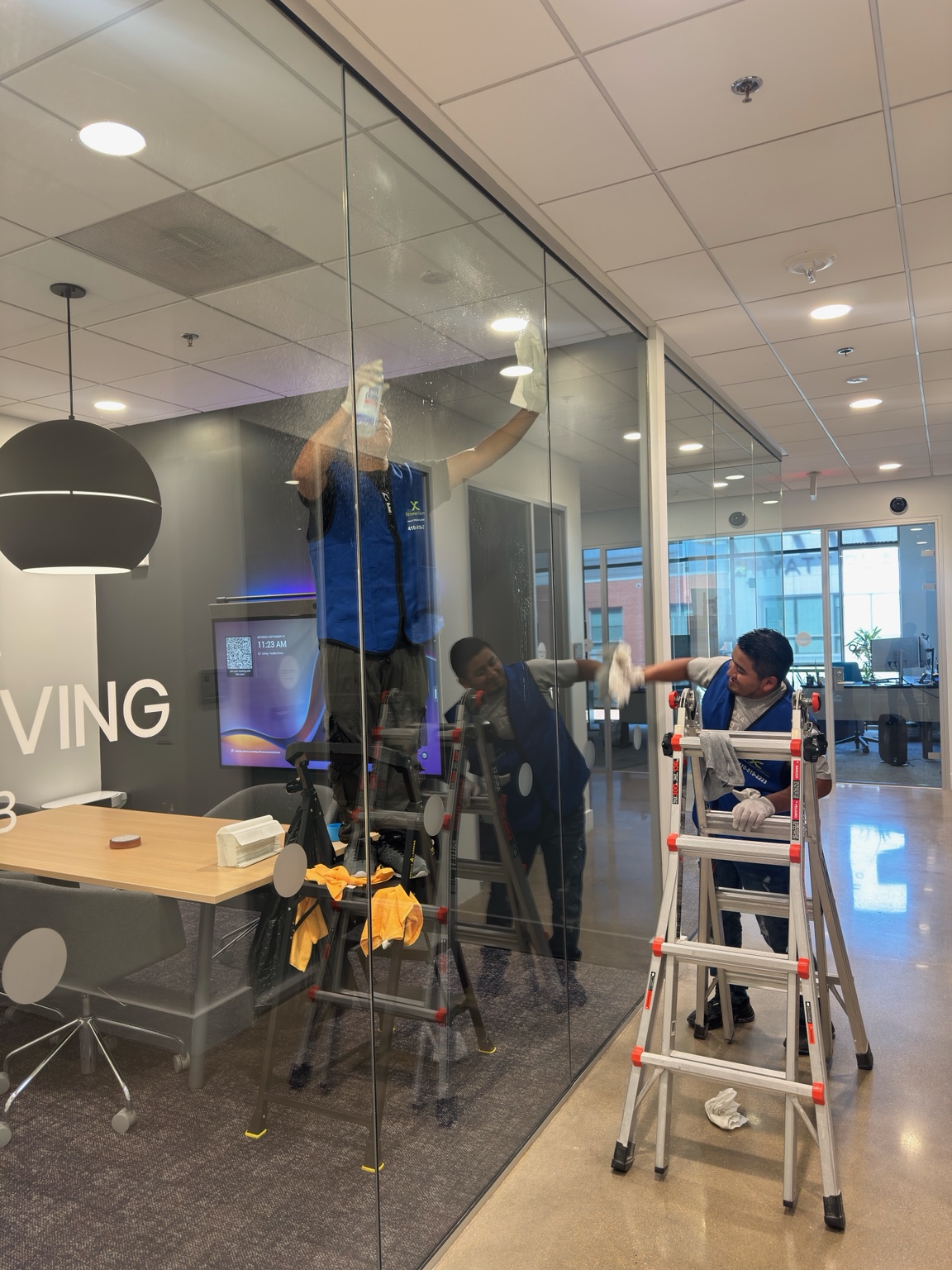 Xtreme Cleans staff cleaning glass office partitions