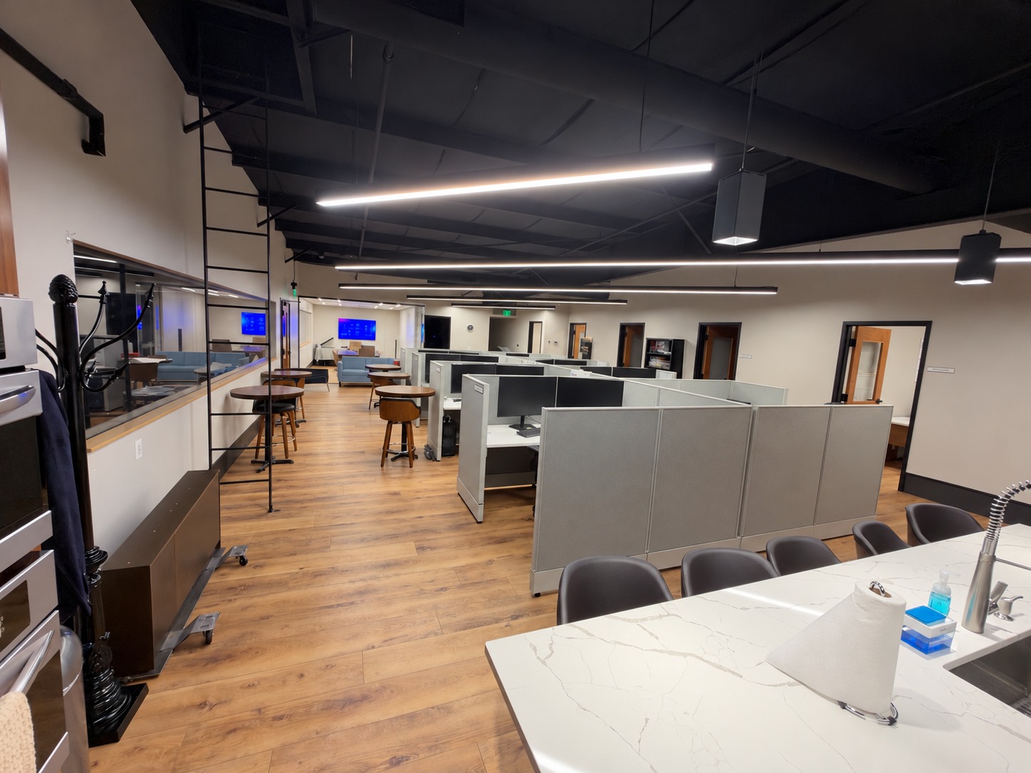 Office suite with cubicles, shared kitchen, and hard-surface floors