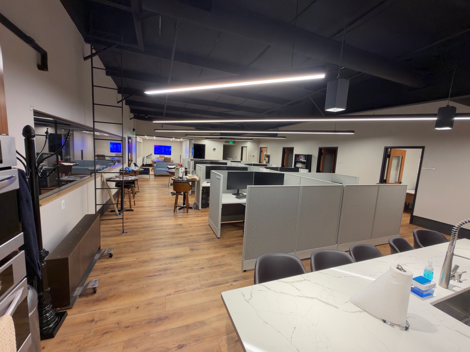 Office suite with cubicles, shared kitchen, and hard-surface floors