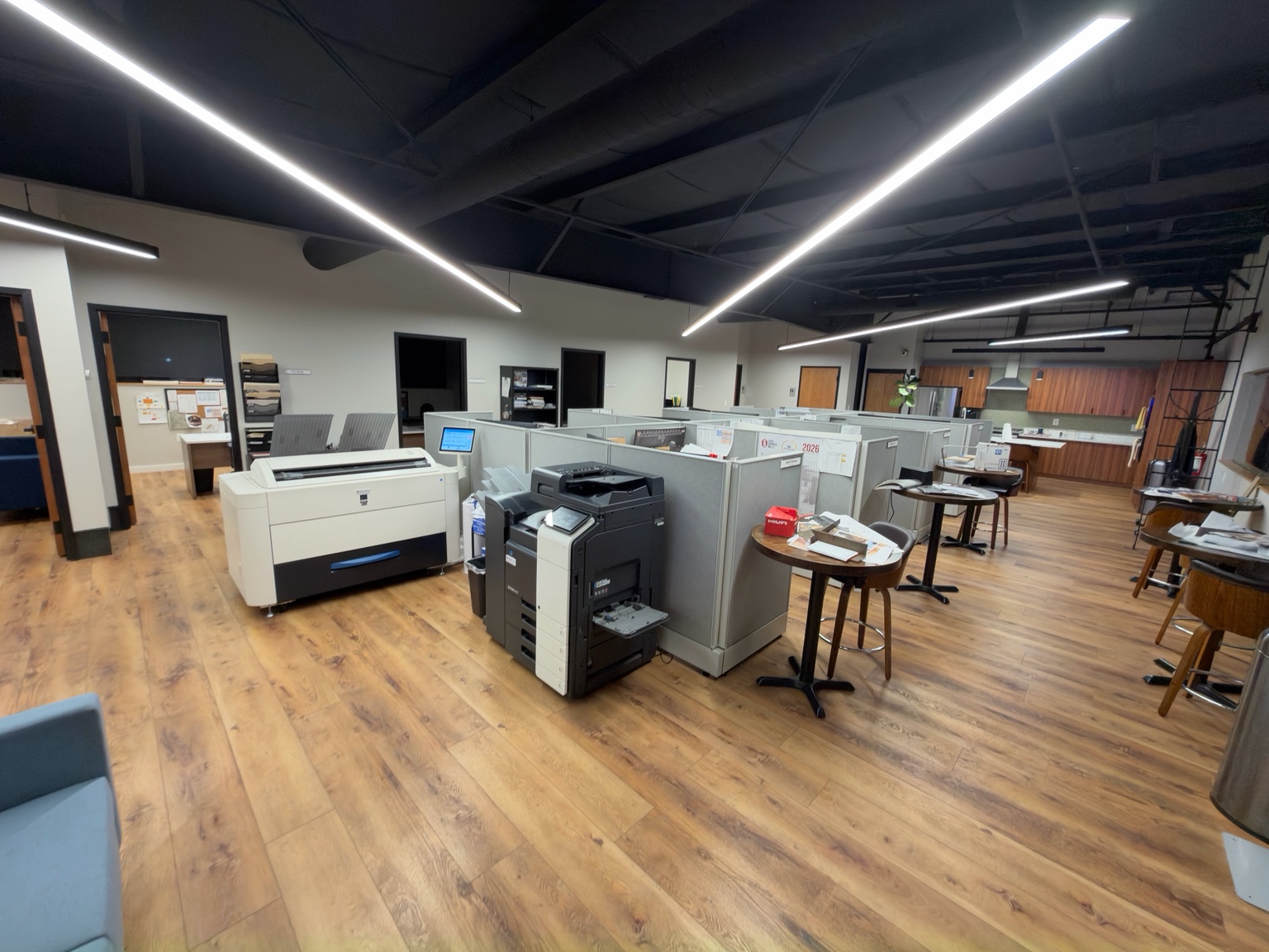 Commercial office workspace with cubicles and hard-surface floors