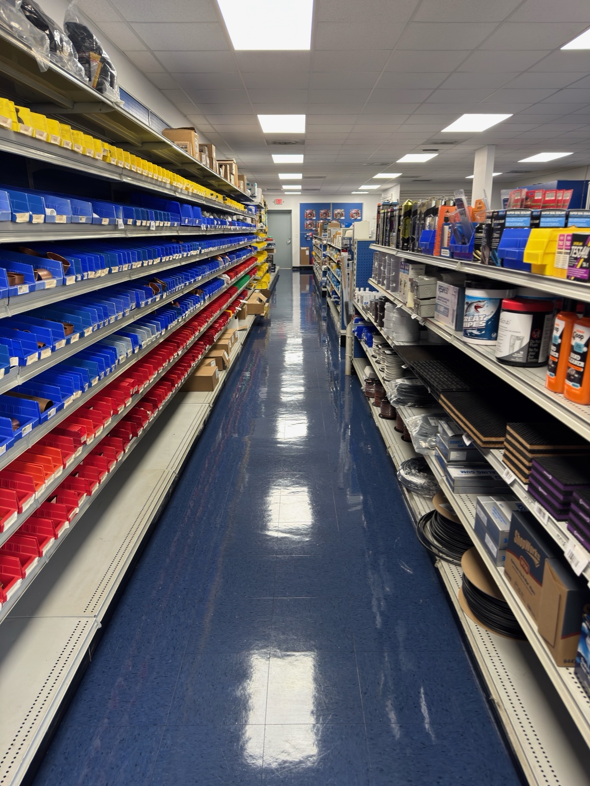 Glossy blue flooring inside a retail aisle