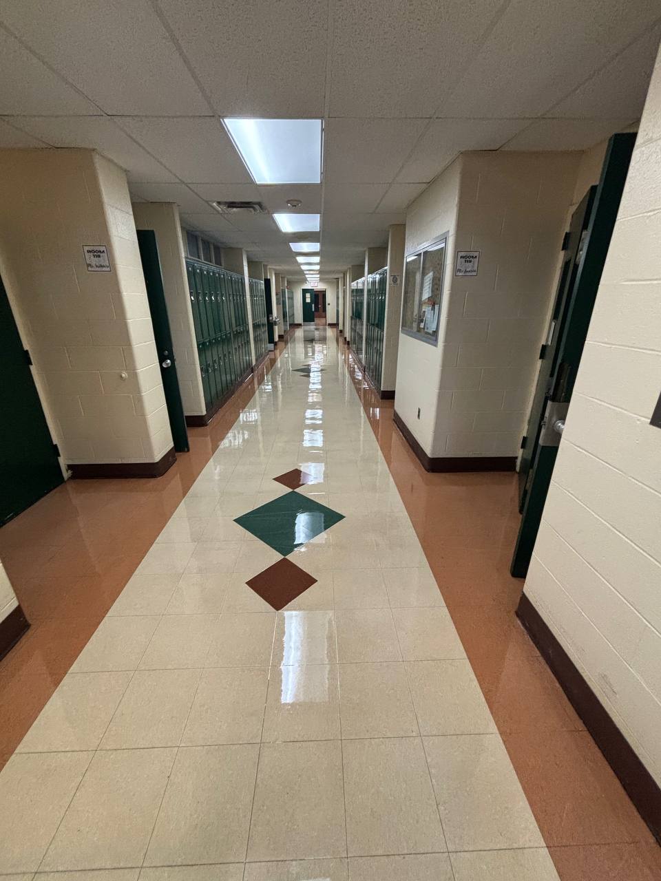 School hallway with lockers and reflective patterned flooring